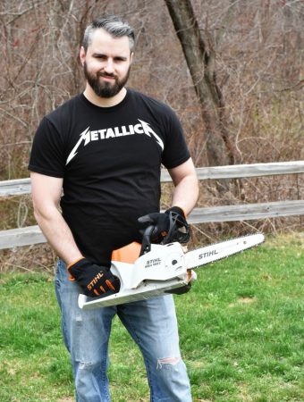 man holding battery powered Stihl chainsaw