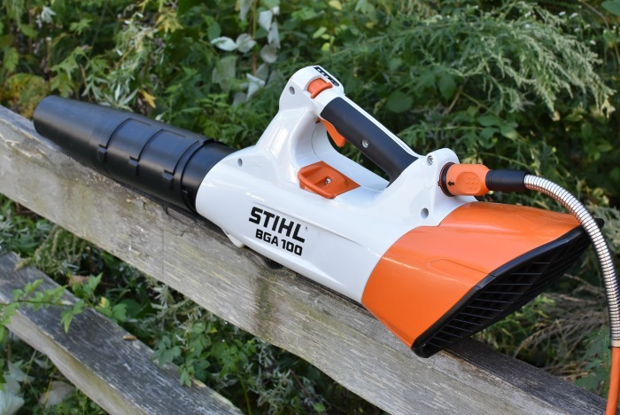 Stihl Handheld Battery Blower sitting on fence rail.