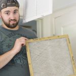 man holding dirty air filter