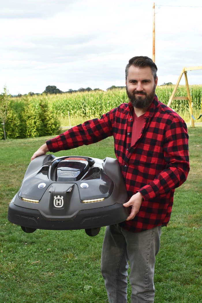 Man holding the Husqvarna Automower 450XH