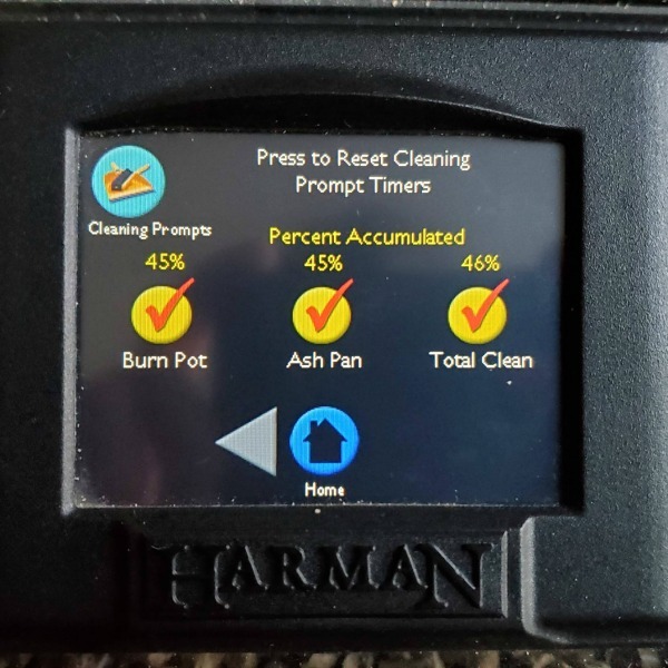 Harman pellet stove digital display of cleaning prompts. Burn Pot, Ash Pan, and Total Clean percent accumulated.