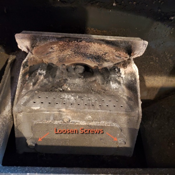 igniter cover with a caption that says "loosen screws" and an arrow pointing to each of the 2 screws.