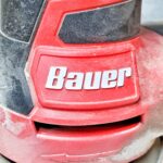 close-up of Bauer palm sander showing logo