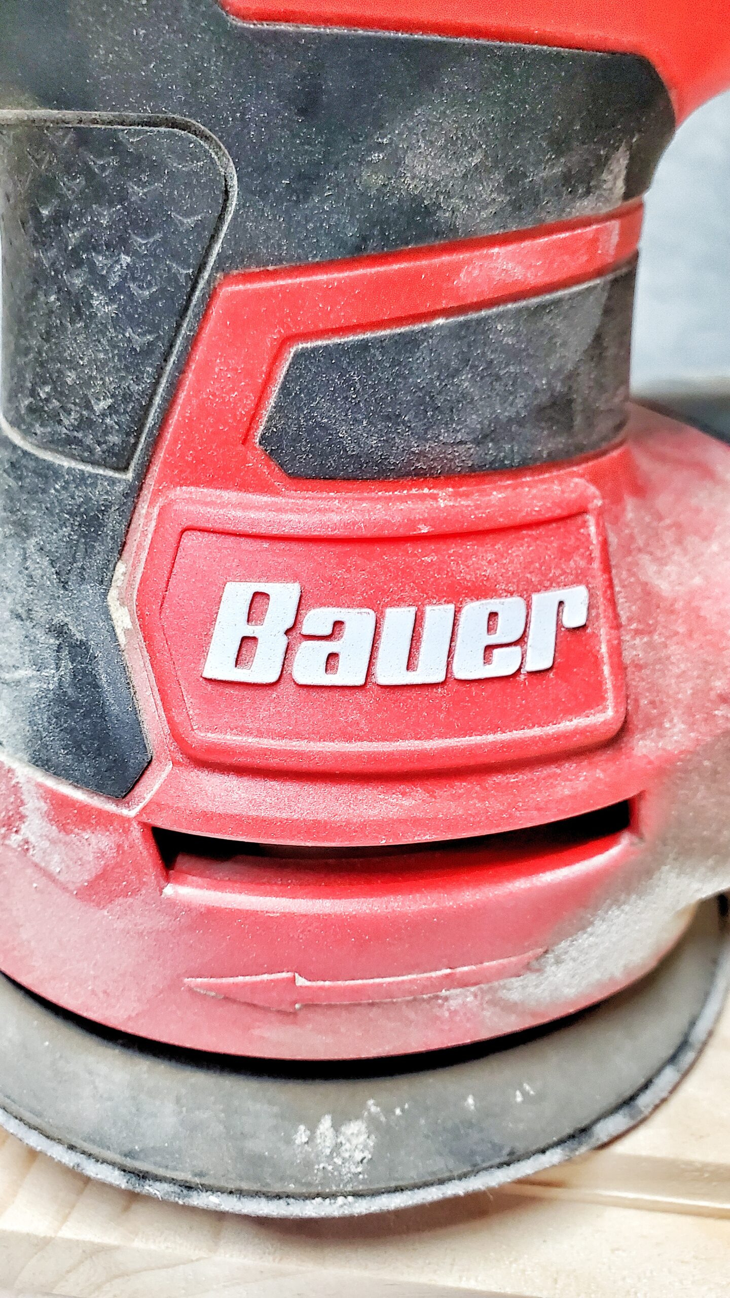 close-up of Bauer palm sander showing logo