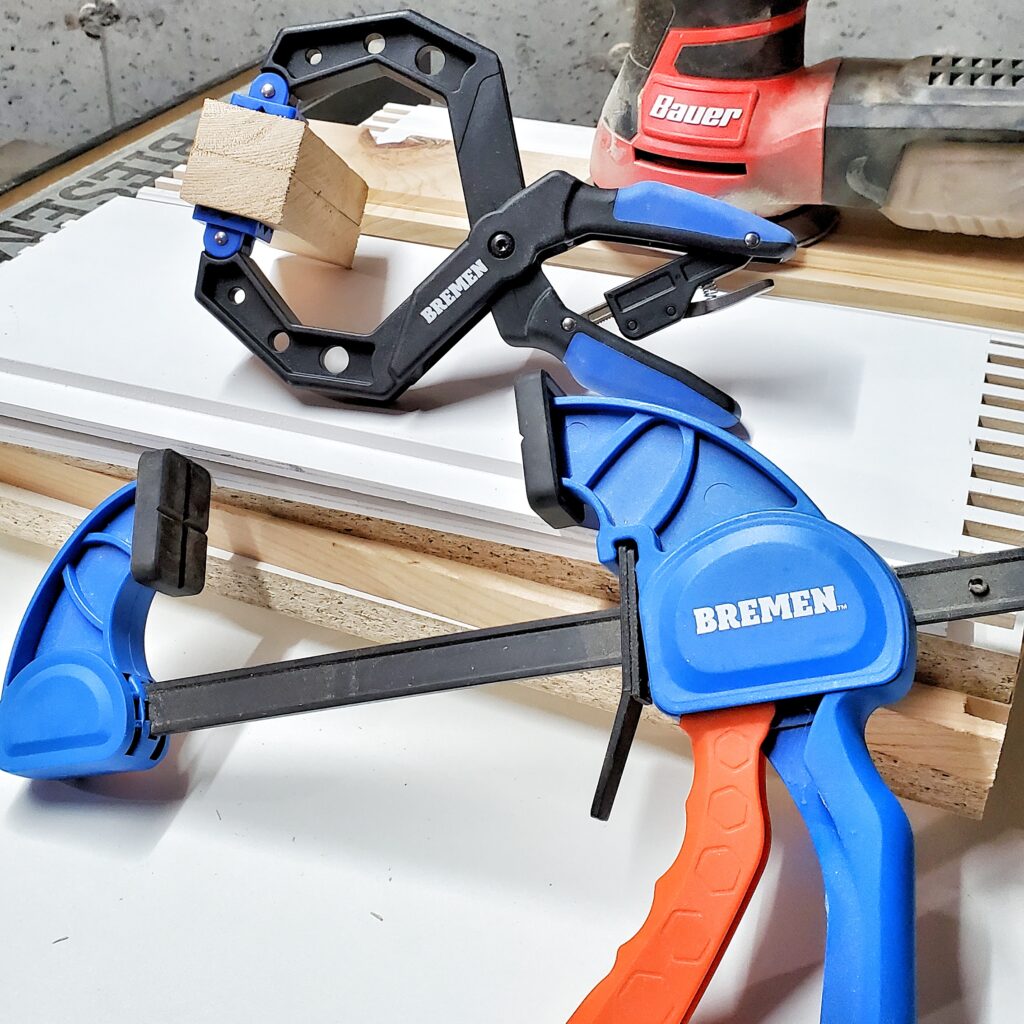 Bremen clamps and Bauer oscillating sander on wood boards