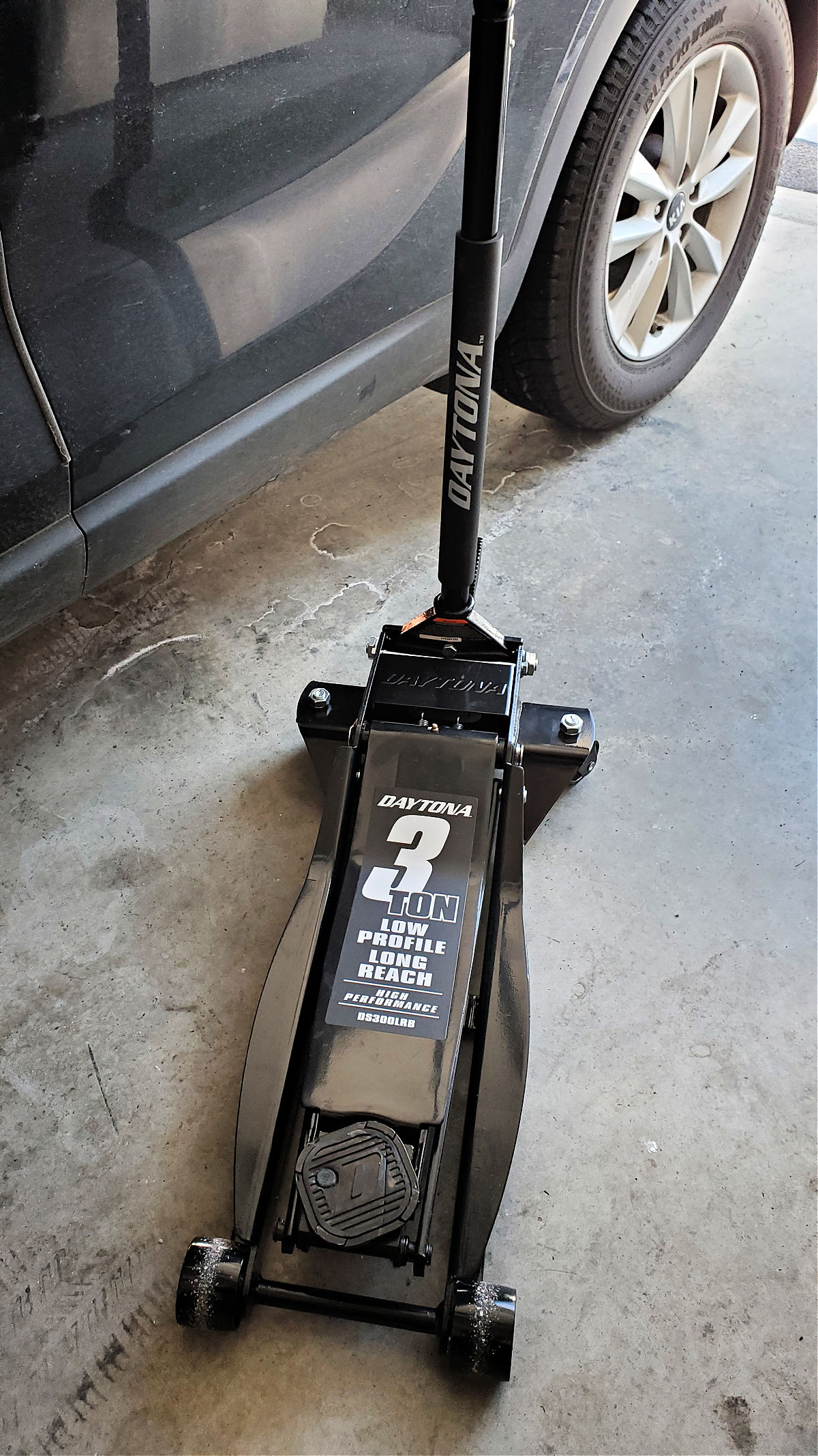 black 3-ton floor jack on garage floor